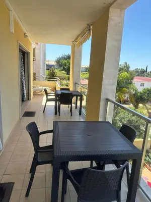 a patio with a table and chairs on a balcony at Jardins da guia in Albufeira