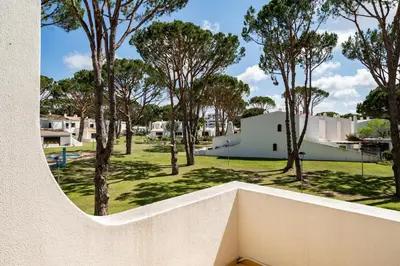 a view of a park with trees and a building at Vilamouratenis Sunscape by SAPvillas in Vilamoura