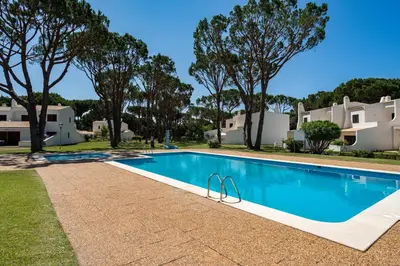 a swimming pool in front of some houses at Vilamouratenis Sunscape by SAPvillas in Vilamoura