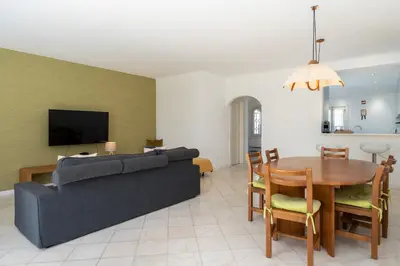 a living room with a couch and a table at Vilamouratenis Sunscape by SAPvillas in Vilamoura