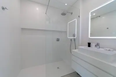 a white bathroom with a sink and a mirror at Villa Marina - 33 by HelloVacations in Albufeira