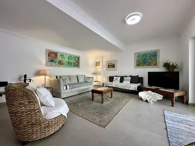a living room with a couch and a tv at Vilamoura Grand Terrace with Pool by Homing in Vilamoura