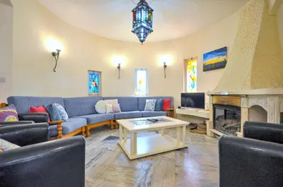 a living room with couches and a fireplace at Villa Atlantico in Quarteira
