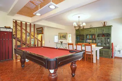 a living room with a pool table in it at Villa Atlantico in Quarteira
