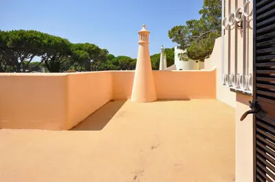 a lighthouse sits on the side of a building at Villa Gardenia in Quarteira