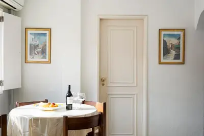 a table with a plate of fruit and a bottle of wine at LUIS - Vilamoura in Vilamoura