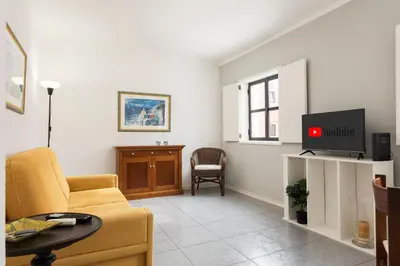a living room with a couch and a tv at LUIS - Vilamoura in Vilamoura