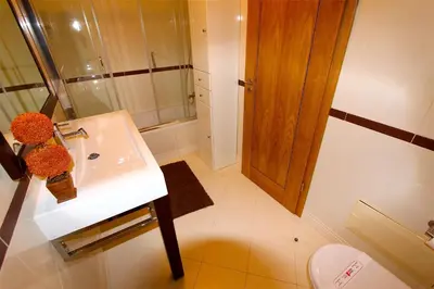 a bathroom with a sink and a shower and a toilet at Antelius 82 - Clever Details in Vilamoura