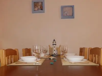 a dining room table with glasses and a lighthouse on it at Alta Oura in Albufeira