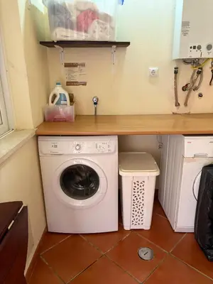 a washing machine under a counter in a kitchen at Casa Oasis - Paraiso na Terra in Tunes