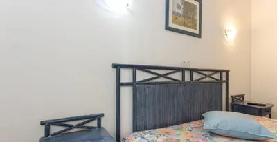 a bedroom with a bed with a black frame at Residencial Miramar in Quarteira