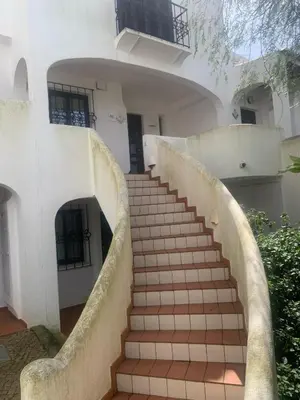 a staircase leading up to a white house at Apartamento Perfect Holidays in Albufeira