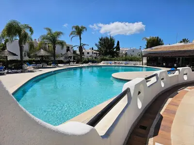a large swimming pool with blue water in a resort at Apartamento Perfect Holidays in Albufeira