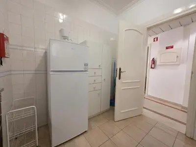 a kitchen with a white refrigerator and a door at Marina Mar Retreat by SAPvillas in Vilamoura