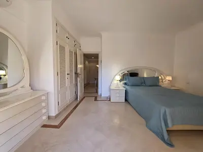 a bedroom with a bed and a mirror on the wall at Marina Mar Retreat by SAPvillas in Vilamoura