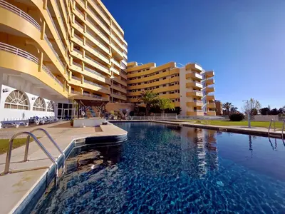 a swimming pool in front of a large building at Marina Mar Retreat by SAPvillas in Vilamoura