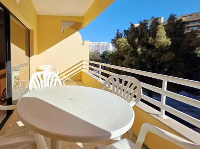 a white table and chairs on a balcony at Marina Mar Retreat by SAPvillas in Vilamoura