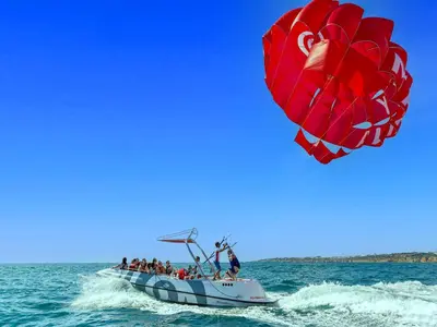 a group of people on a boat with a large kite at Luxury Apart wStunning Sea Views, walk Galé Beach Albufeira in Albufeira