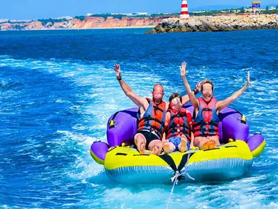 a group of people sitting on a raft in the water at Luxury Apart wStunning Sea Views, walk Galé Beach Albufeira in Albufeira