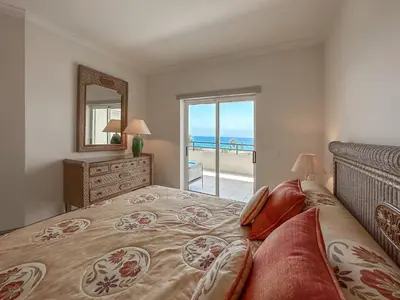 a bedroom with a bed with a view of the ocean at Luxury Apart wStunning Sea Views, walk Galé Beach Albufeira in Albufeira