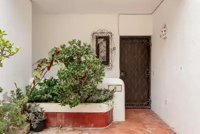 a door to a house with plants in front of it at Estúdio 21 em Santa Bárbara de Nexe - Faro in Santa Bárbara de Nexe