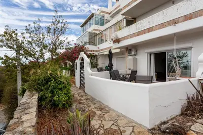 a white house with a porch and a patio at Estúdio 21 em Santa Bárbara de Nexe - Faro in Santa Bárbara de Nexe