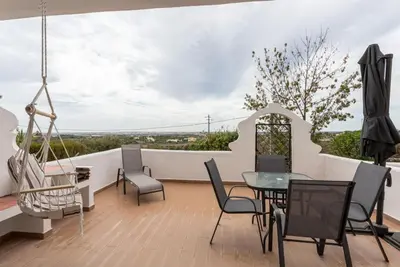 a balcony with a table and chairs and a view at Estúdio 21 em Santa Bárbara de Nexe - Faro in Santa Bárbara de Nexe