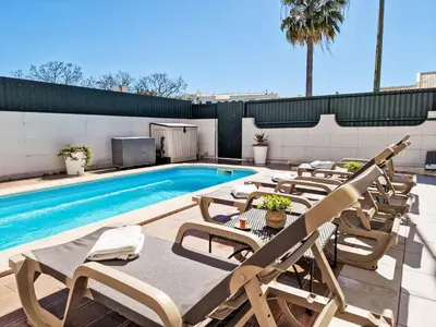a pool with chaise lounge chairs and a swimming pool at Holiday Home V2 Caliços - VIP Properties by Interhome in Albufeira