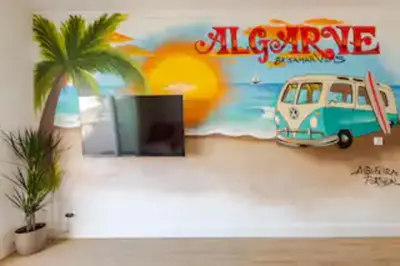 a wall with a mural of a van and a palm tree at Brisamar Villas OCEANS in Albufeira