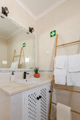 a bathroom with a sink and a mirror at Brisamar Villas OCEANS in Albufeira