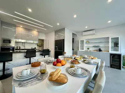 a white table with food on it in a kitchen at Quarteira Deluxe With Pool by Homing in Quarteira