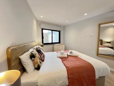 a bedroom with a large bed and a mirror at Albufeira Stylish 2 With Pool by Homing in Albufeira