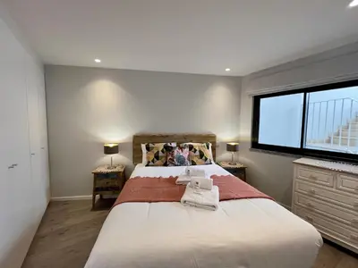 a bedroom with a large bed and a window at Albufeira Stylish 2 With Pool by Homing in Albufeira