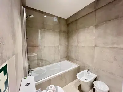 a bathroom with a tub and a toilet and a sink at Albufeira Stylish 2 With Pool by Homing in Albufeira