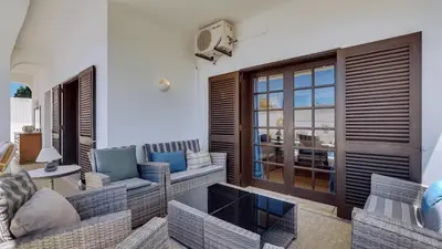 a living room with a couch and chairs and a television at Villa Frederique by Gabi Miguel in Albufeira