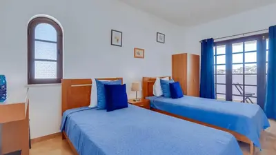 two beds in a room with blue sheets at Villa Frederique by Gabi Miguel in Albufeira
