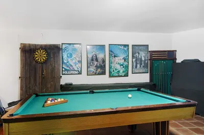a room with a pool table and pictures on the wall at Villa Rústica in Albufeira