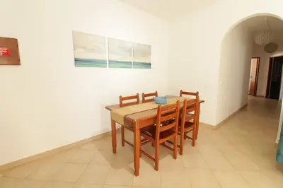 a dining room with a wooden table and chairs at Old Town Apartments 2D in Albufeira