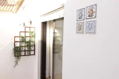 a door to a store with paintings on the wall at Old Town Apartments 2D in Albufeira