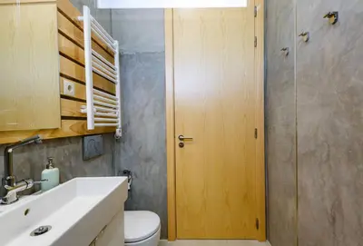 a bathroom with a toilet and a sink and a door at Casa da Calma, Vale do Lobo in Almancil