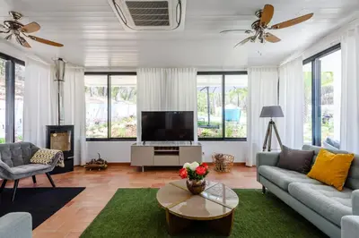 a living room with a couch and a tv at Casa da Calma, Vale do Lobo in Almancil