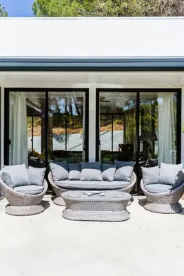 a group of couches sitting in front of a building at Casa da Calma, Vale do Lobo in Almancil