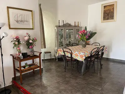a dining room with a table with chairs and flowers at Villa Snoppy in Albufeira
