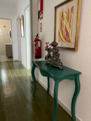 a green table in a hallway with a fire hydrant at Villa Snoppy in Albufeira