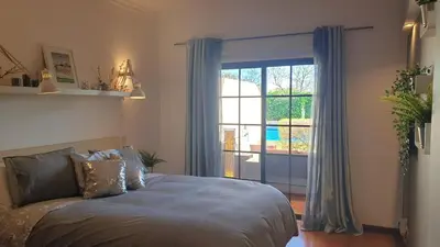 a bedroom with a bed and a large window at Vilamoura Paradisus Laguna with Patio and Pool in Quarteira