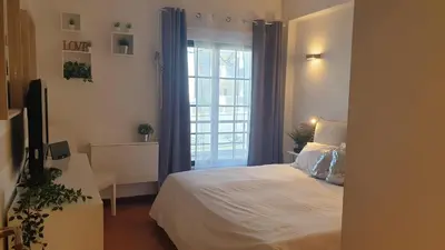 a bedroom with a white bed and a window at Vilamoura Paradisus Laguna with Patio and Pool in Quarteira