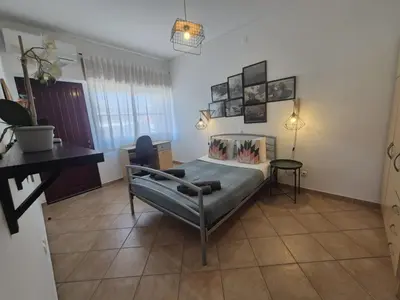 a bedroom with a bed and a table in it at Casa da Baixa in Faro