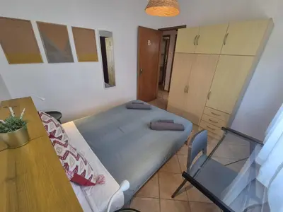 a bedroom with a bed and a table and a desk at Casa da Baixa in Faro