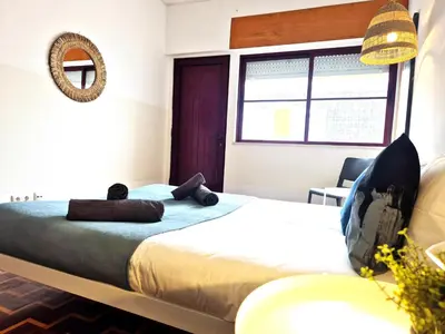 a bedroom with a bed with two teddy bears on it at Casa da Baixa in Faro