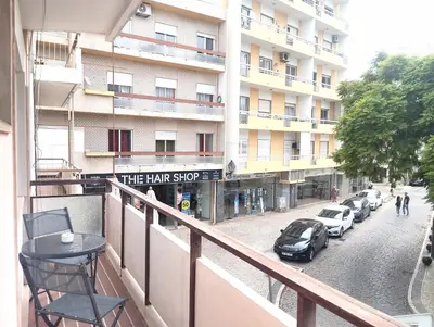 a balcony of a hotel with a sign that reads the hair shop at Casa da Baixa in Faro